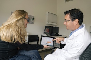 Dr. Ari Green and a colleague demonstrate how doctor and patient would sit side by side as they discuss patient data using the BioScreen app. ©Regents of the University of California — San Francisco.